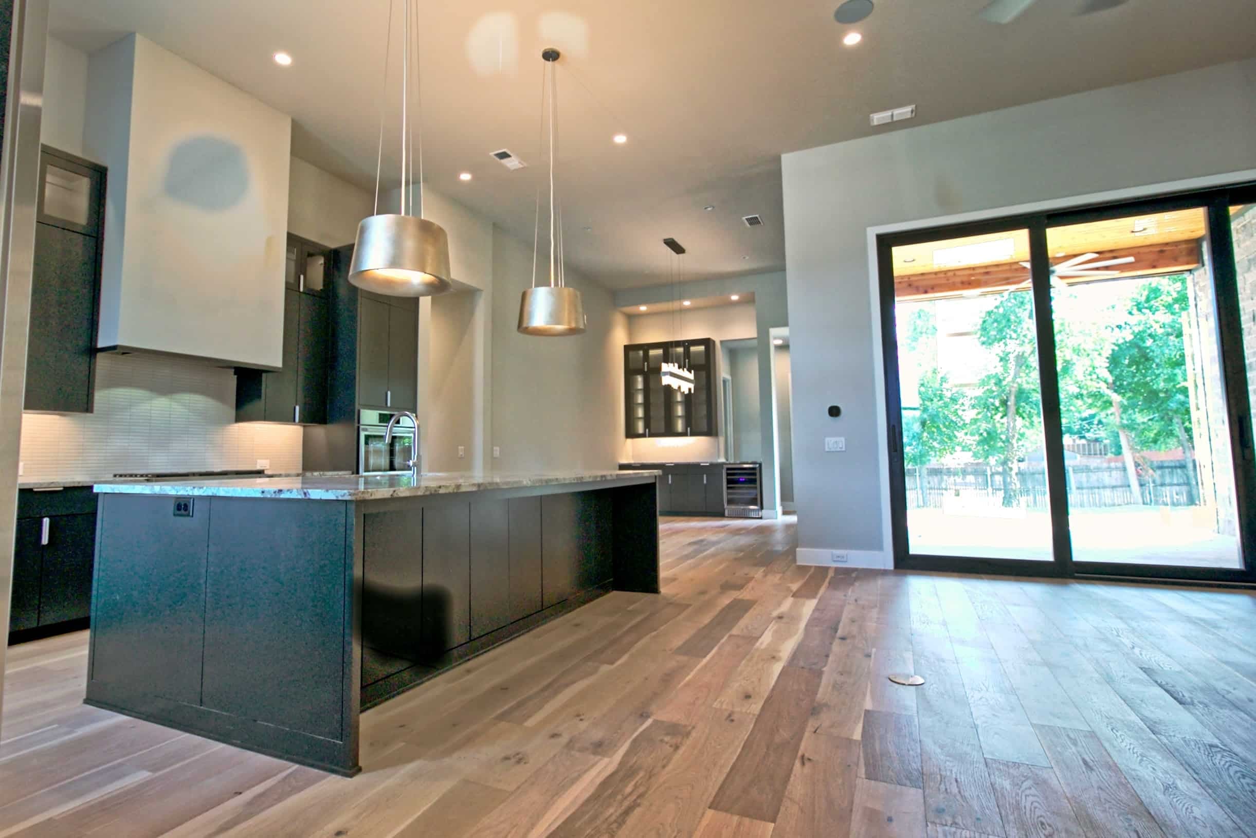 Luxury custom home interior featuring modern kitchen design — built by Oakmark Custom Homes, expert Texas home builders.